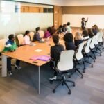Professional team engaged in a collaborative boardroom meeting with a presentation in progress.