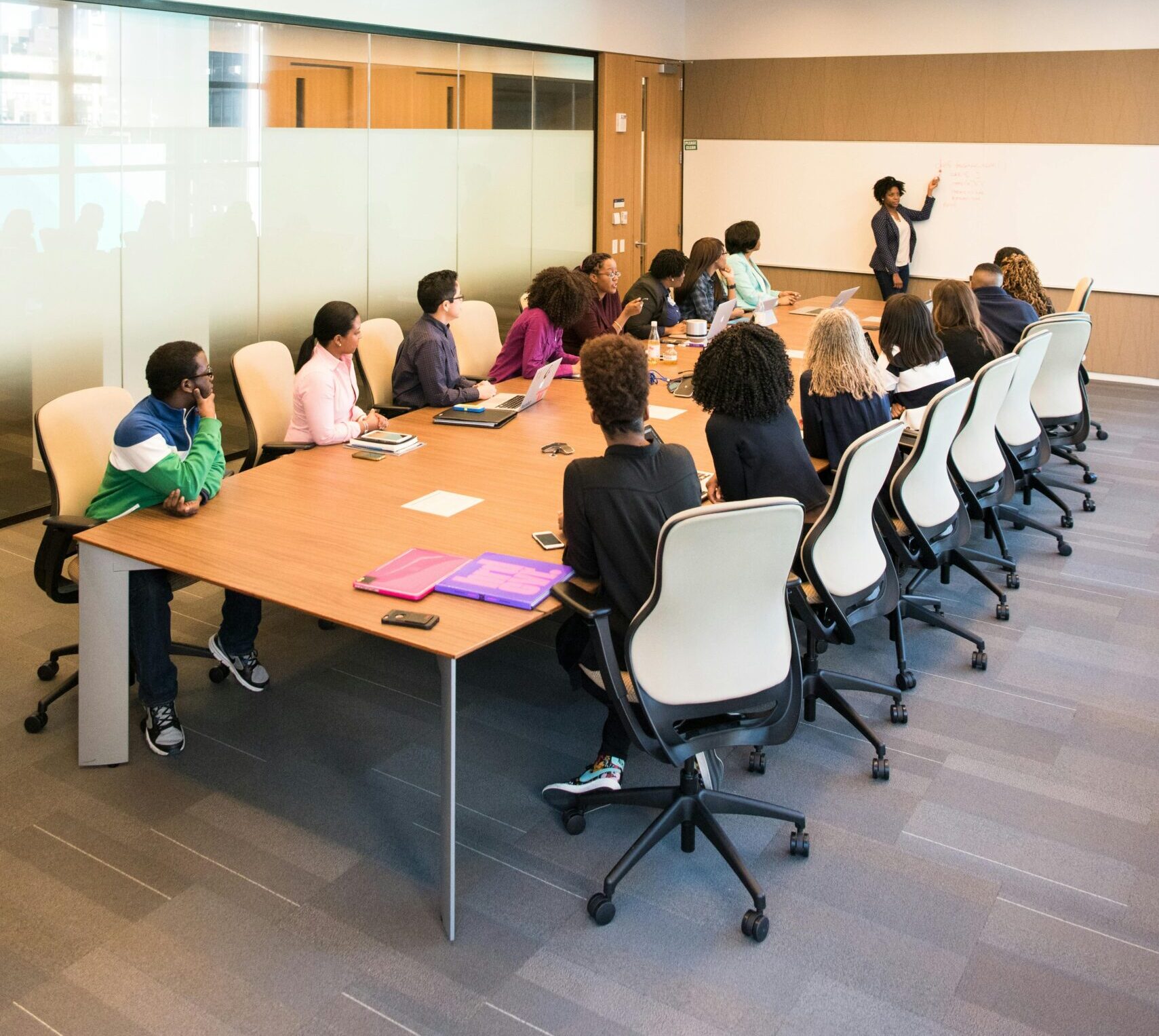 Professional team engaged in a collaborative boardroom meeting with a presentation in progress.